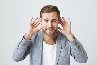 Man Gesturing That He Can't Hear